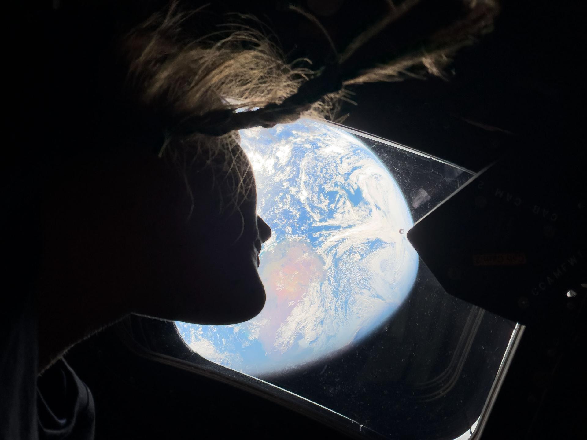 Christina Koch peering at Earth through Orion.